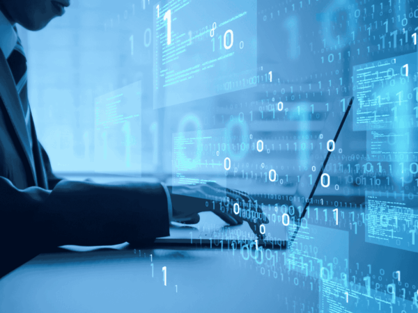 Business professional’s hands typing on a laptop keyboard, with floating binary digits (1s and 0s) and translucent code windows overlaid—symbolizing data processing and cybersecurity in a modern office setting.
