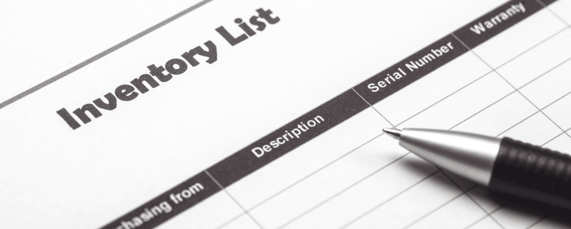 Close-up of an IT device inventory list form with columns for description, serial number, and warranty, alongside a pen, representing IT asset tracking and management services provided by an MSP in the San Francisco Bay Area.