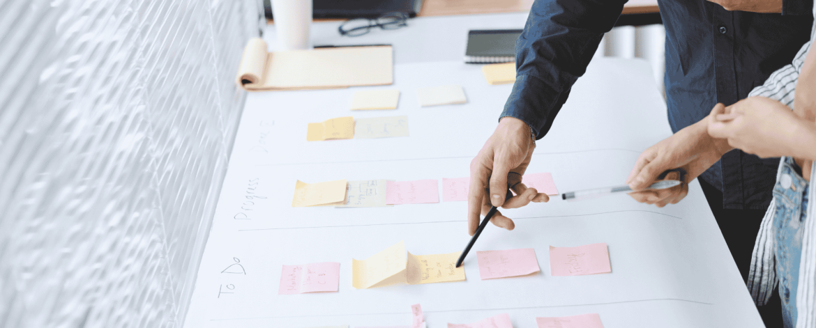 "IT project planning meeting with Kanban board and sticky notes – technology roadmap development for small and mid-sized Bay Area companies."