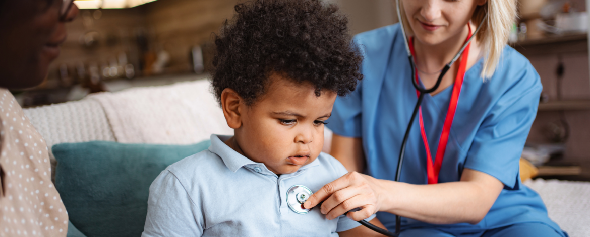 Home healthcare provider checking child patient vital signs during in home medical visit using secure healthcare technology systems.