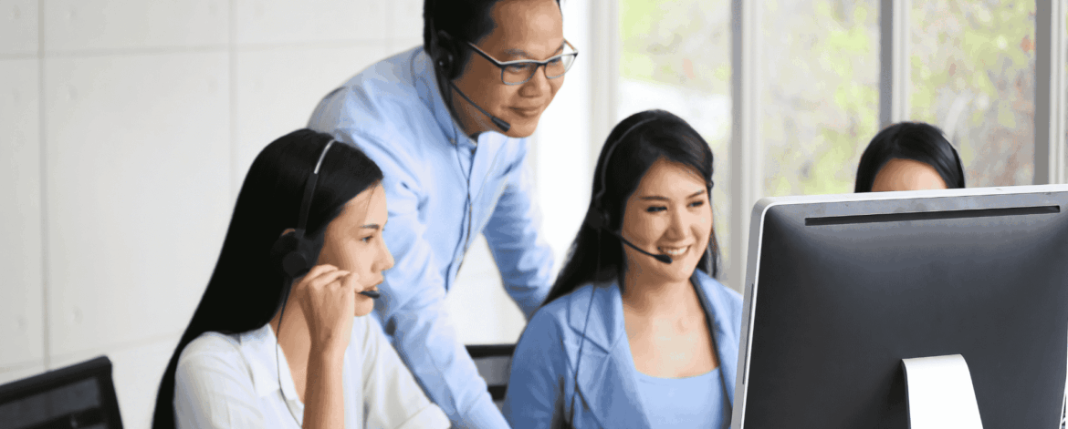 Office team collaborating with IT support staff, highlighting the need to upgrade from non-IT employee support to a managed service provider.