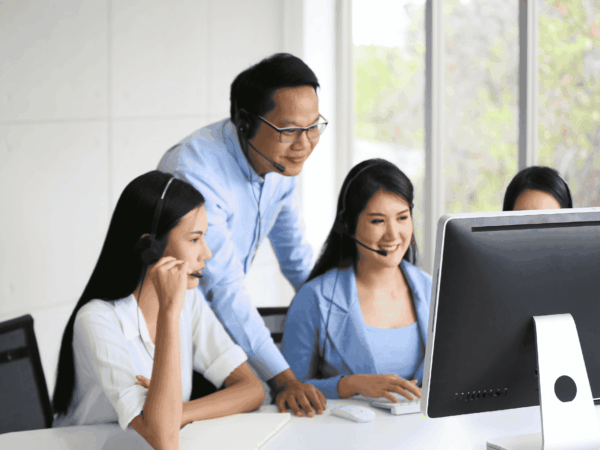 Office team collaborating with IT support staff, highlighting the need to upgrade from non-IT employee support to a managed service provider.