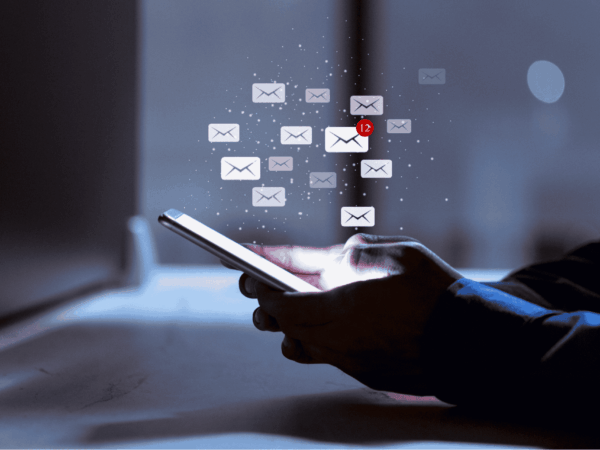 Smartphone displaying incoming email notifications highlighting risks of phishing attacks and importance of email security for businesses.