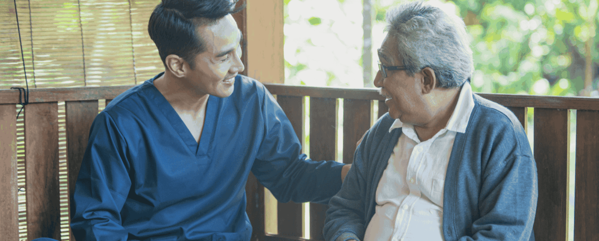 Caregiver helping senior patient use a tablet for secure access to healthcare information and digital systems in home-based care