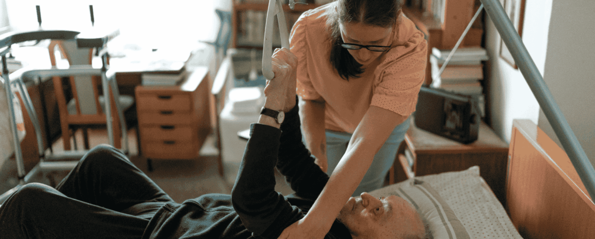 Caregiver assisting elderly patient with physical therapy at home highlighting need for secure and reliable endpoint protection in home-based care.