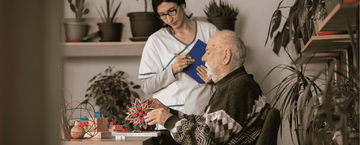 Healthcare worker monitoring elderly patient activity during home visit representing secure handling of patient data through endpoint protection solutions.