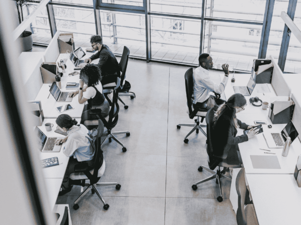 Former employee carrying a box of office belongings symbolizing employee departures, secure offboarding procedures, and transition management for home care organizations