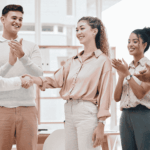 Business professionals shaking hands during a team meeting representing successful employee onboarding and workplace collaboration for home care agencies