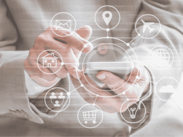 Business professional using a smartphone with digital app icons representing cloud computing, e-commerce, travel, and communication—illustrating mobile IT solutions for small businesses in the San Francisco Bay Area.