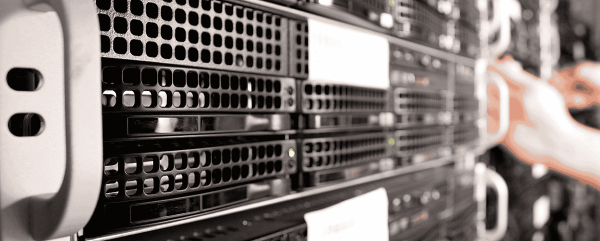 Close-up of a person working on a server rack in a data center, showing multiple black server units with indicator lights and network cables.
