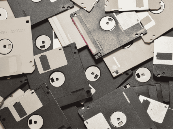 Stack of vintage floppy disks symbolizing data storage and IT history, highlighting secure data management and IT support services for San Francisco Bay Area businesses.