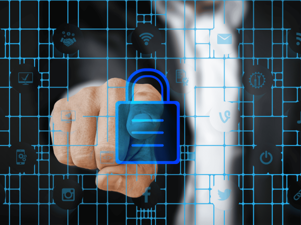 Employee working remotely on laptop with cybersecurity lock screen overlay. IT Total Care provides managed IT support, data security, and endpoint protection for small to mid-sized businesses in the San Francisco Bay Area.