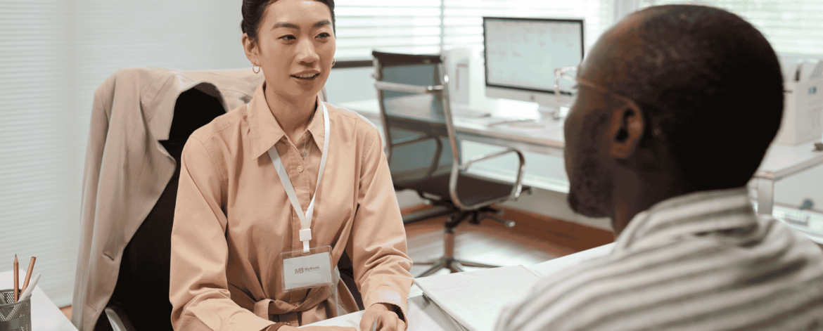 Manager and employee in an off-boarding meeting reviewing final steps – secure removal of system access and retrieval of company devices.