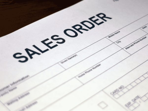 Close-up of a sales order form used to document IT hardware purchases and track procurement details.