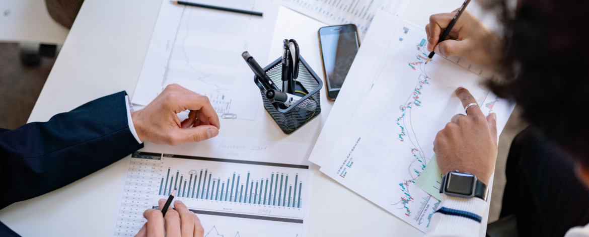 Team analyzing charts and system performance metrics to evaluate technical debt, infrastructure risk, and cybersecurity vulnerabilities