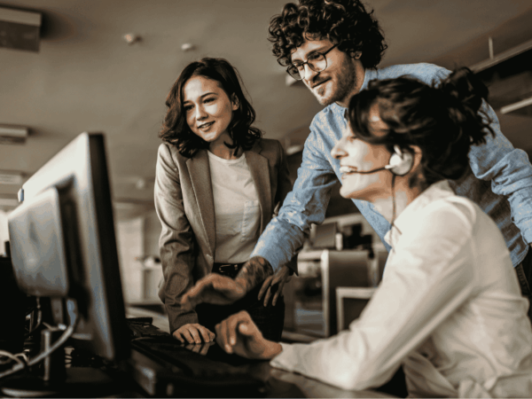 Customer support professionals using headsets in an office environment, representing professional MSP support replacing family IT assistance.