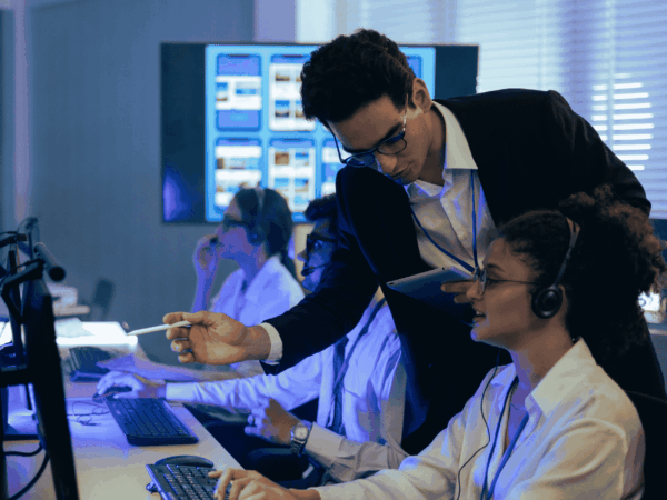 Help desk professional reviewing IT documentation, demonstrating challenges of relying on non-IT employees for technical support.