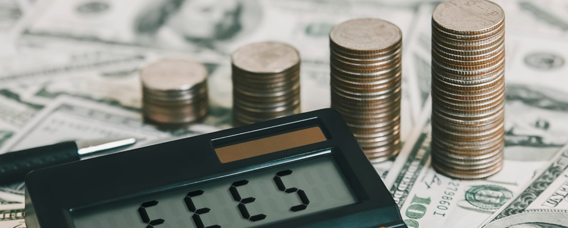 Calculator displaying fees with stacked coins and dollar bills representing unexpected IT service costs and hidden MSP fees