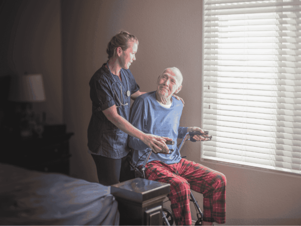 Home care provider supporting group of seniors during activity emphasizing need for reliable SaaS backup to protect care records and operational data.