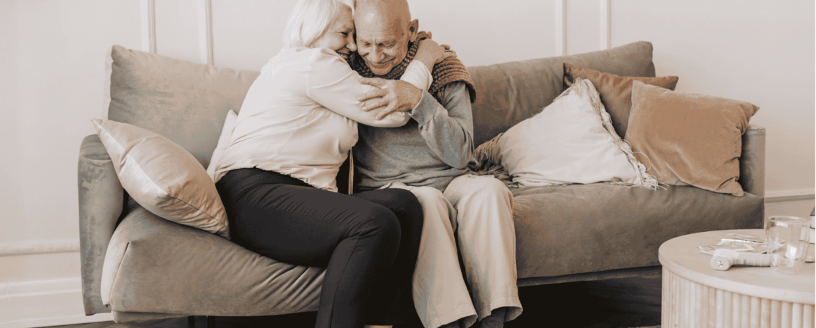 Senior couple embracing at home representing trust and importance of safeguarding sensitive patient information through secure cloud backup solutions.