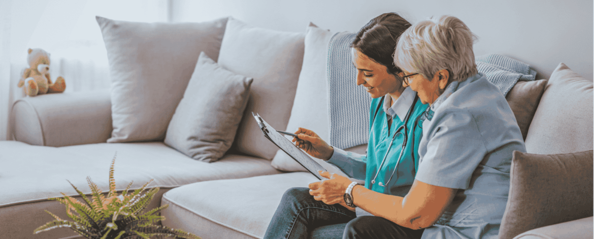Home-based care professionals reviewing patient information together in a living room setting emphasizing reliable network connectivity and secure healthcare communication