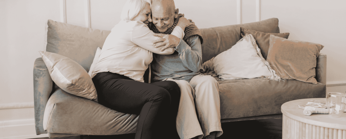 Don't Lose It All 2 Family member comforting elderly man on couch representing the human impact of data loss and the need for secure backup and cybersecurity protection