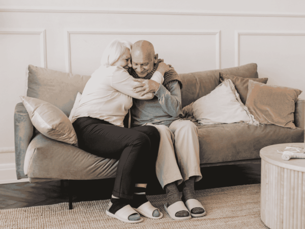 Don't Lose It All 2 Family member comforting elderly man on couch representing the human impact of data loss and the need for secure backup and cybersecurity protection