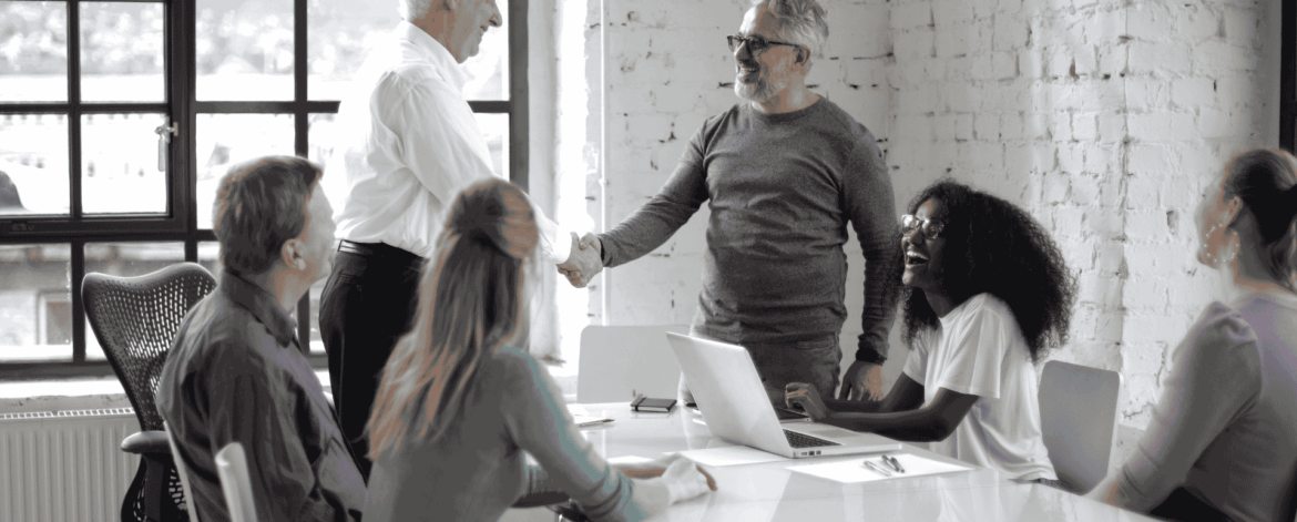 Employee Onboarding for Home Care Agencies 2 New employee being welcomed by coworkers in an office environment highlighting positive onboarding experiences and team integration