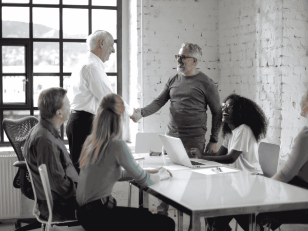 Employee Onboarding for Home Care Agencies 2 New employee being welcomed by coworkers in an office environment highlighting positive onboarding experiences and team integration