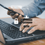 Business professional using smartphone and laptop with secure login screen representing multi factor authentication for home-based care organizations