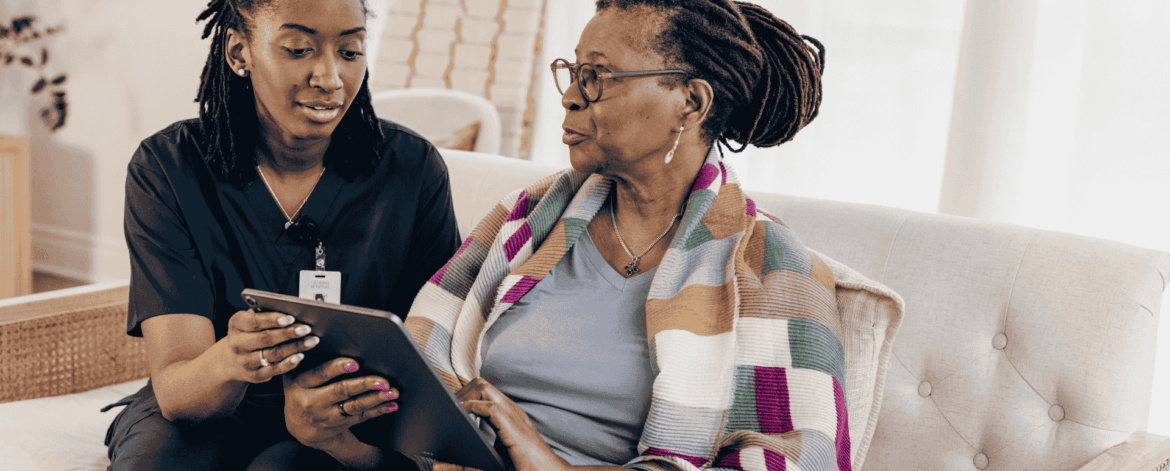 Home Care Password Management 2 Home caregiver assisting elderly woman with conversation and daily support in a home-based care setting emphasizing trust and communication