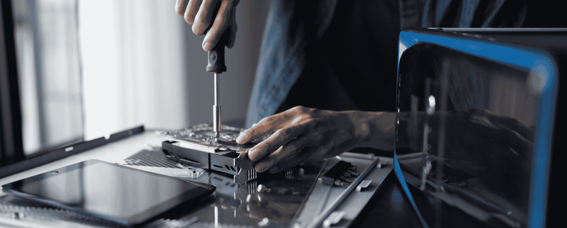 IT Hardware Procurement and Deployment for Home Based Care Agencies 3 Technician performing computer hardware maintenance and device preparation, illustrating IT equipment deployment and lifecycle management for home-based care companies