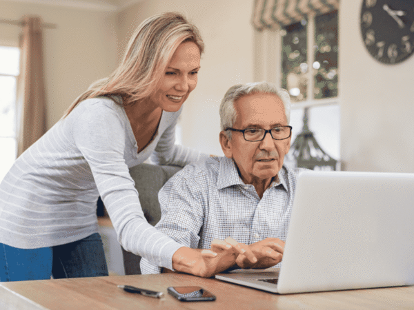 Image 2_9.9.26 Home health staff member and a client working at a laptop in a home, the setting behind the documentation agencies use to verify business associate safeguards.