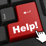 Cursor clicking a red Help key on a black computer keyboard, the moment a hospice coordinator starts asking how to train hospice volunteers on HIPAA.