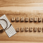 Wooden letter blocks spelling technical support beside a keyboard and headset, the help desk that fields questions like how long must a hospice keep patient records.